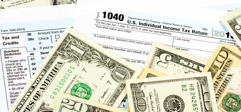 A tax return with cash on top.