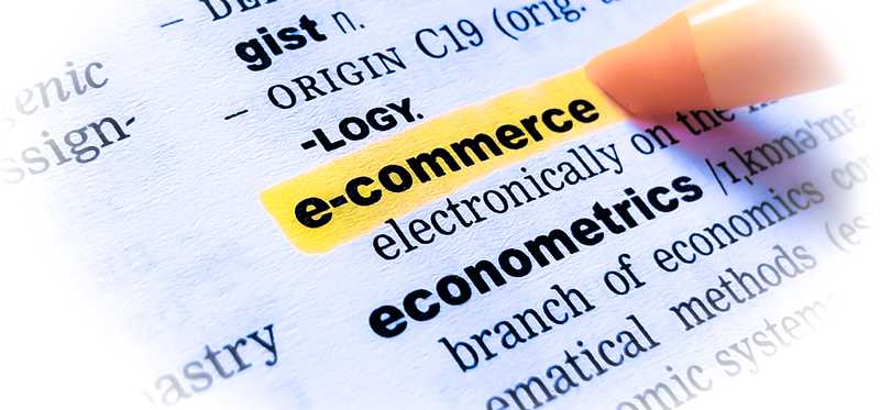 A marker highlights the word E-Commerce in a dictionary.