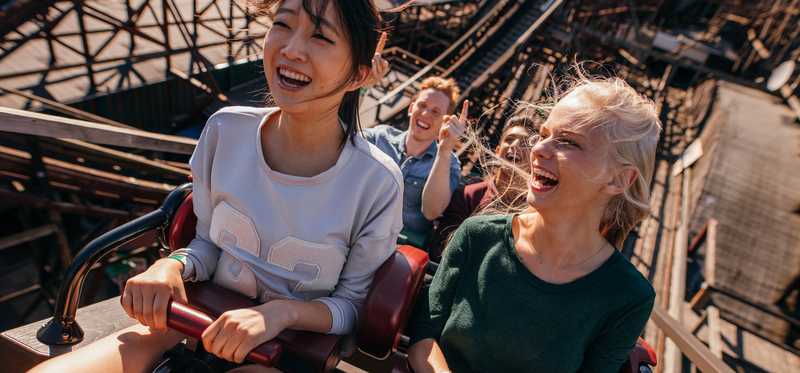 Four people riding a roller coaster.