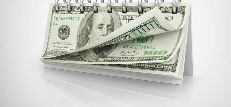 A spiral book made up on hundred dollar bills.