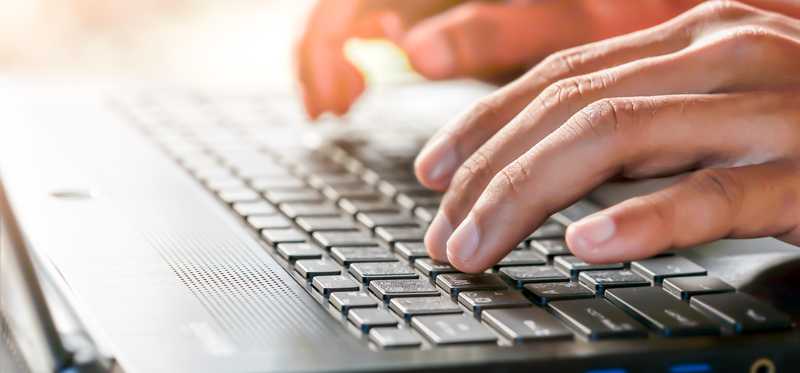 Hands typing on a keyboard.