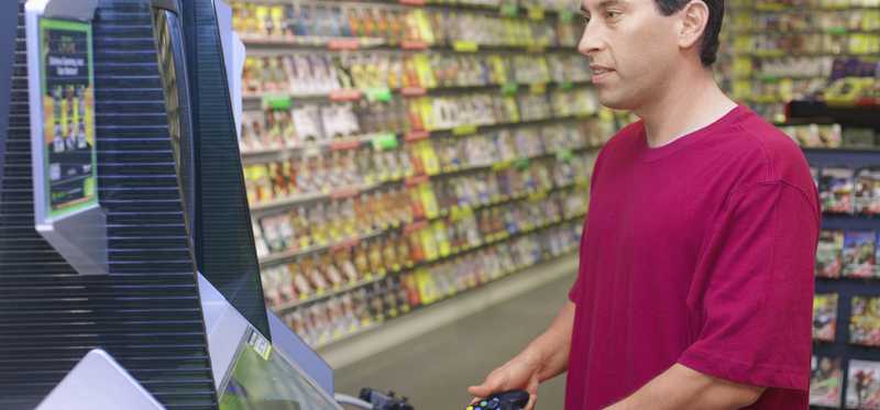 Man playing a video game in a store