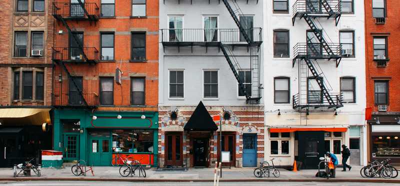 Walkup apartments line a city street in New York City.