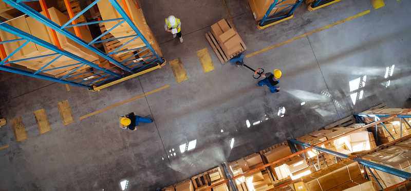 An overhead view of people working in a warehouse.
