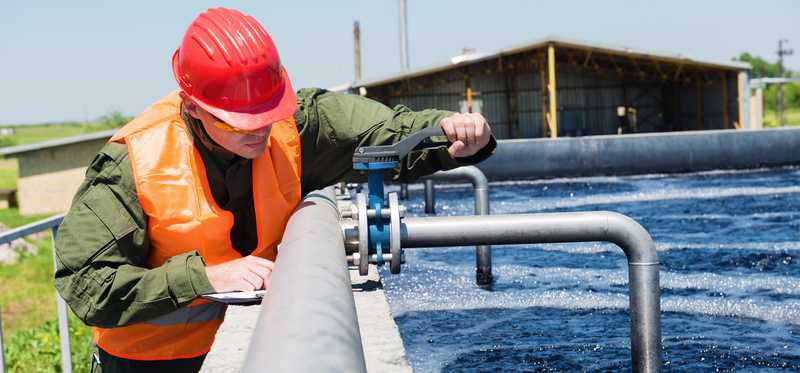 Person working on water pipes.