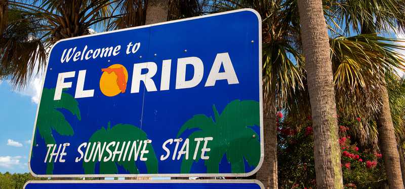 Highway sign that says Welcome to Florida, the Sunshine State.