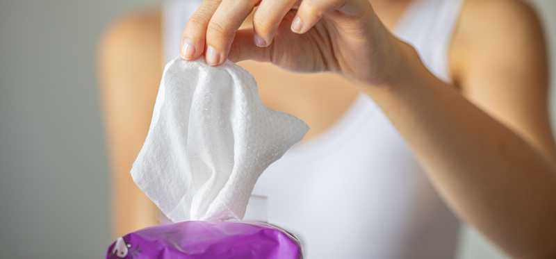 Person pulling out a wipe.
