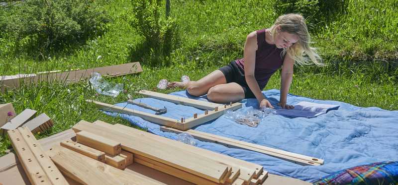 A person assembling IKEA-looking furniture.