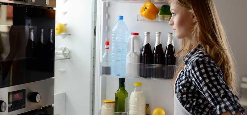 Person looking inside a refrigerator.