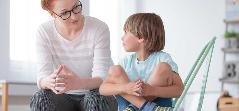 Woman sitting with young boy.