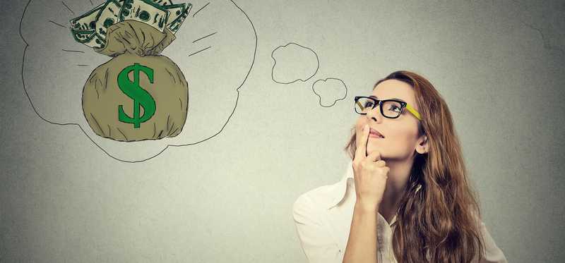 Woman in thought with illustration of money bag above her head.