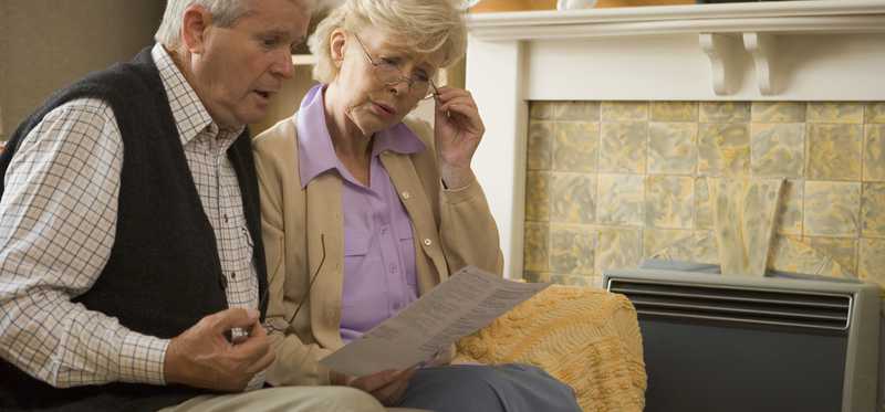 Worried seniors reading document