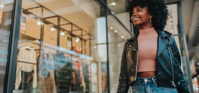 A person passing by a store window.