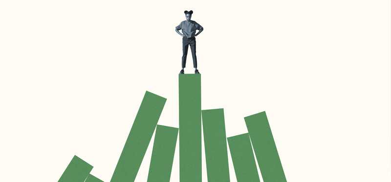 Young woman standing with hands on hips on green block graph against white background