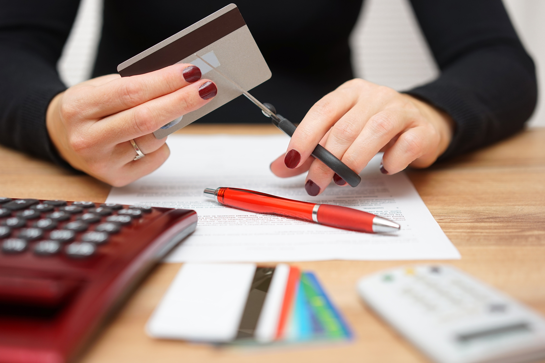 woman cutting a credit card