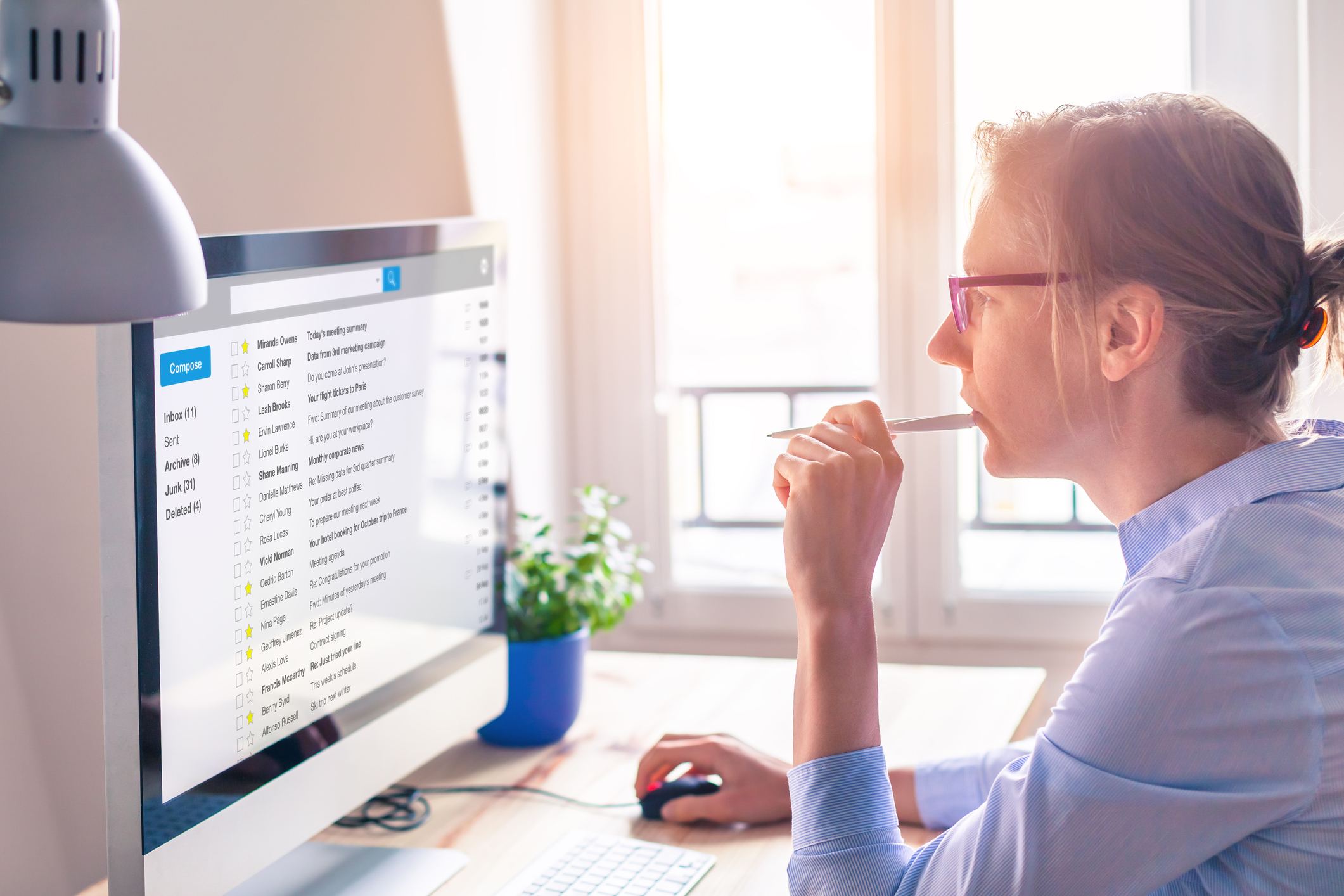 Woman uses desktop computer at home. Woman uses desktop computer at home.