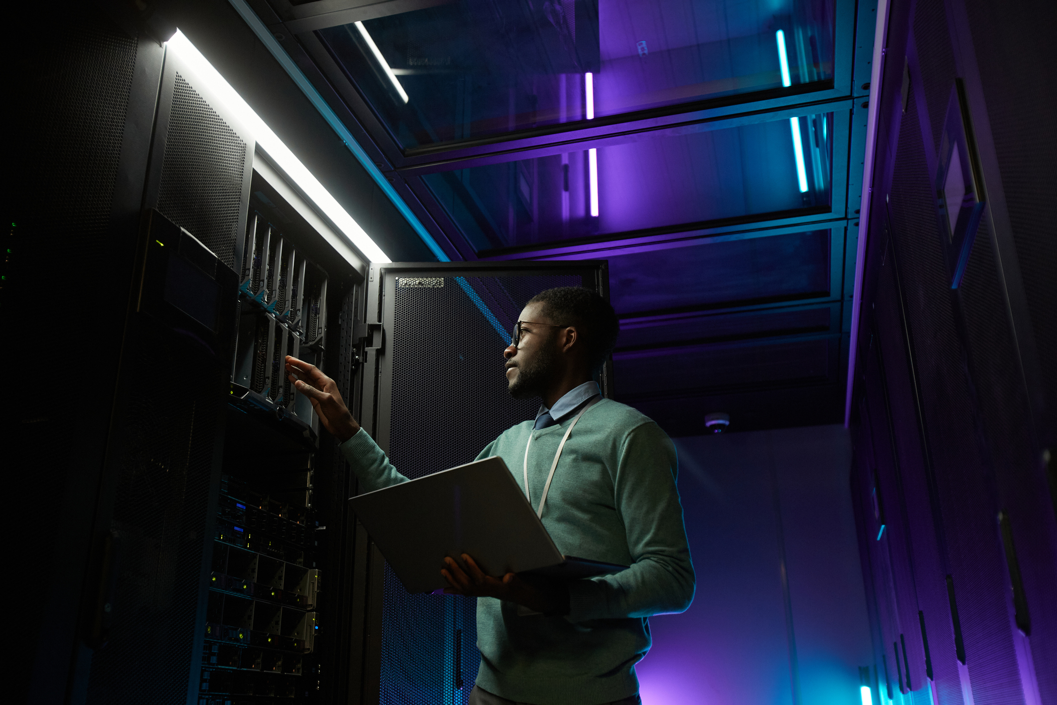 Data center worker A person working at a server rack in a data center.