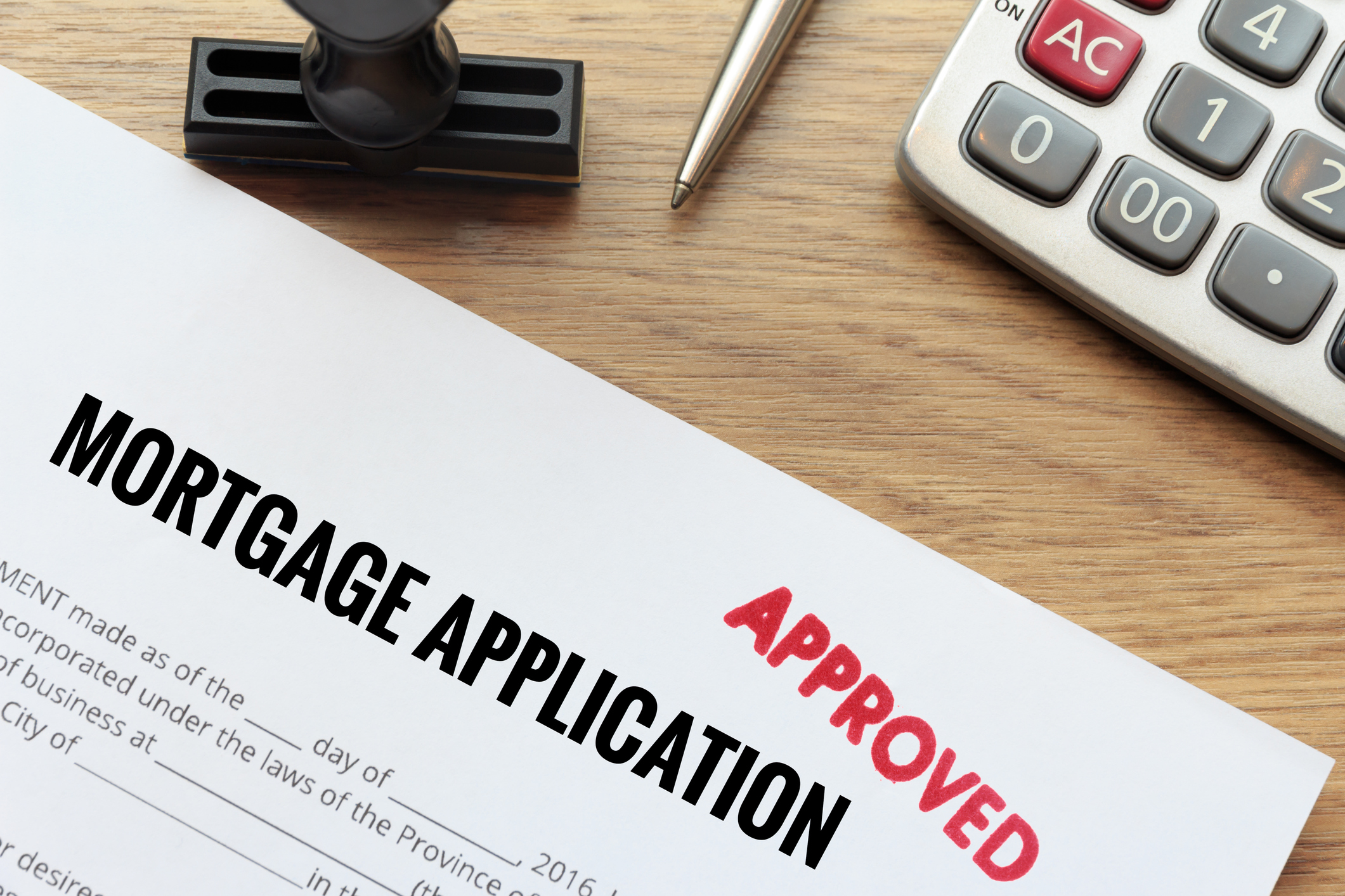 Mortgage application with red Approved stamp