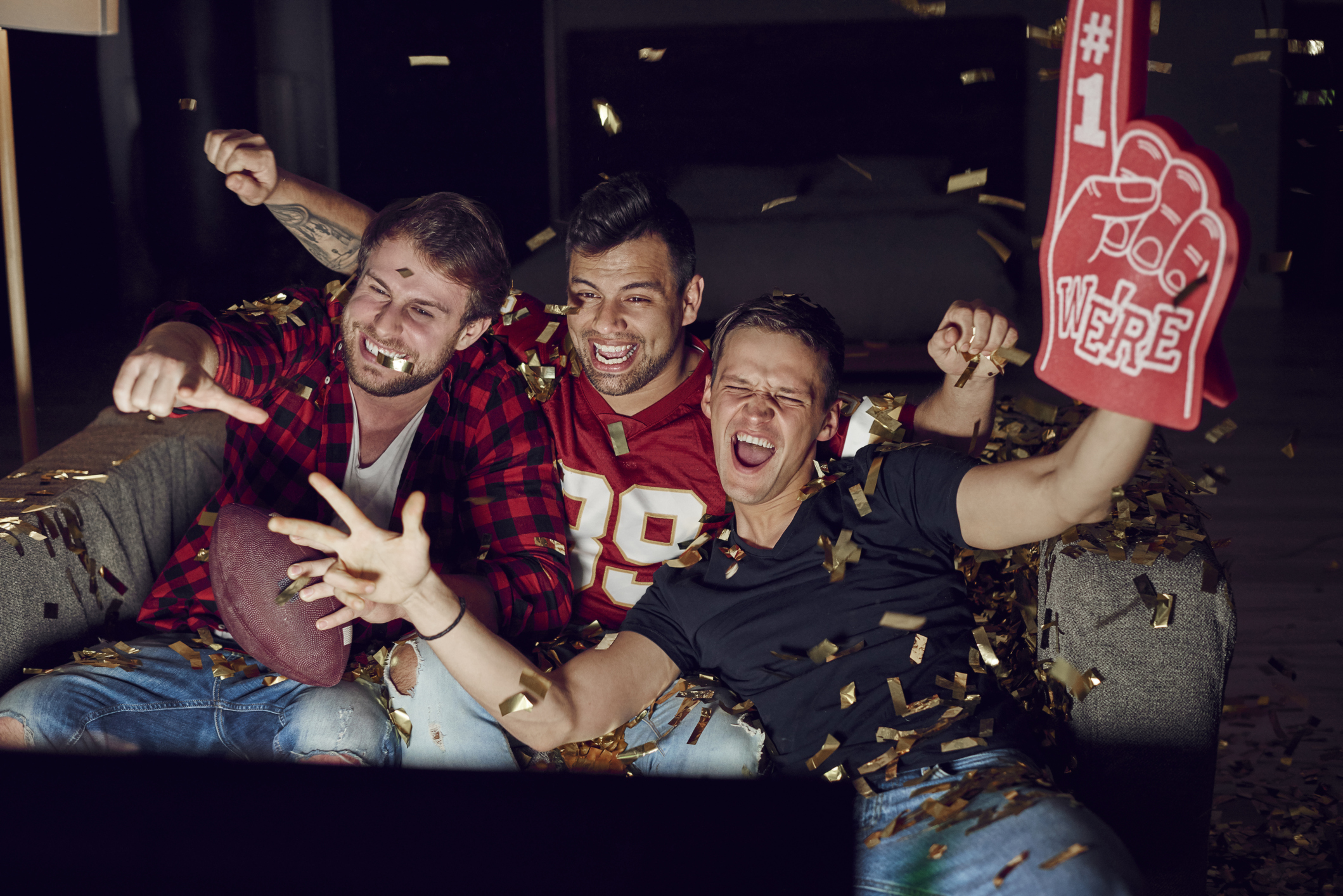 Men watching football on a television Men watching football on a television.