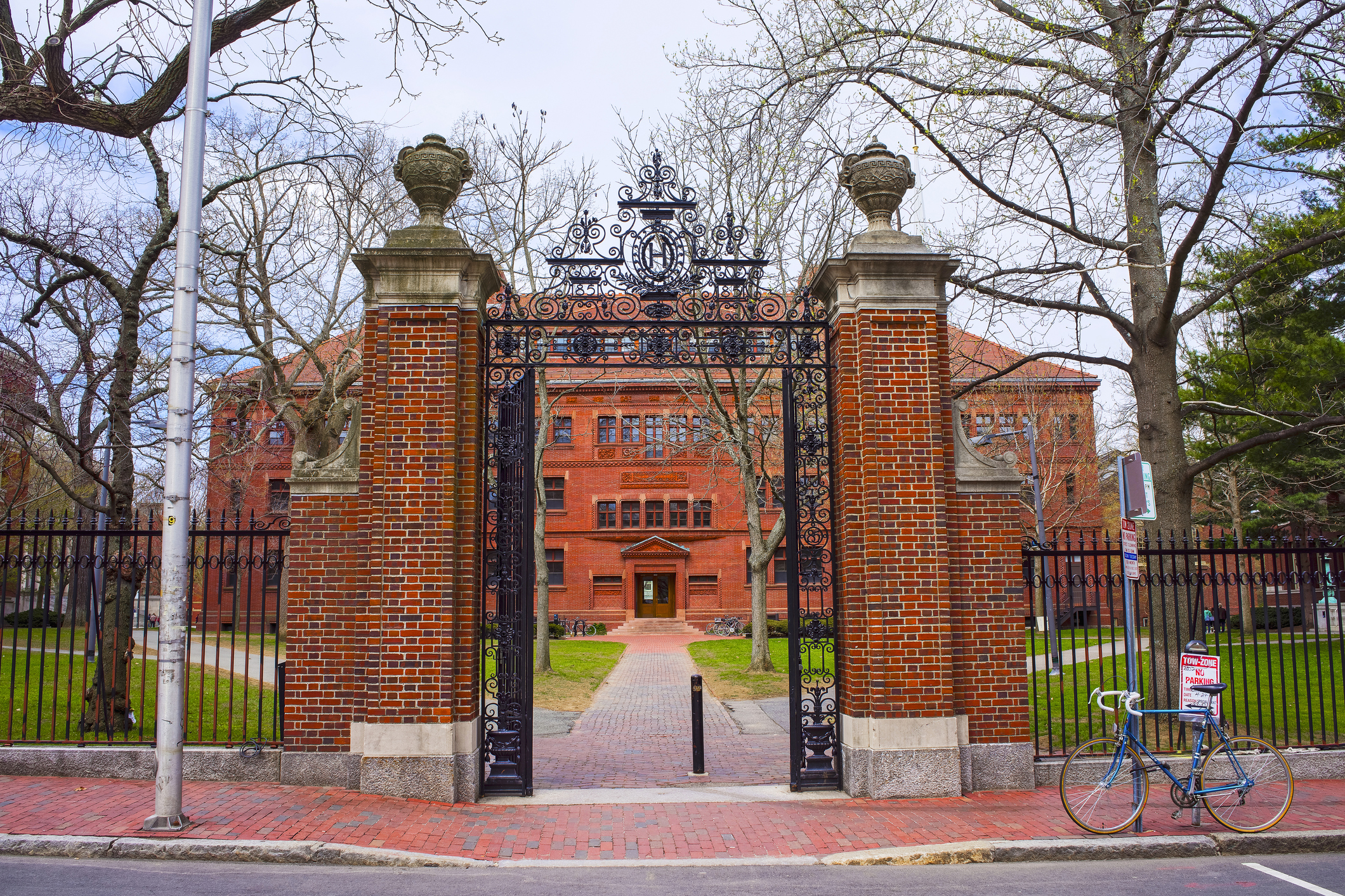 Brick pillar and wrought iron fence entrance to Harvard. Brick pillar and wrought iron fence entrance to Harvard.
