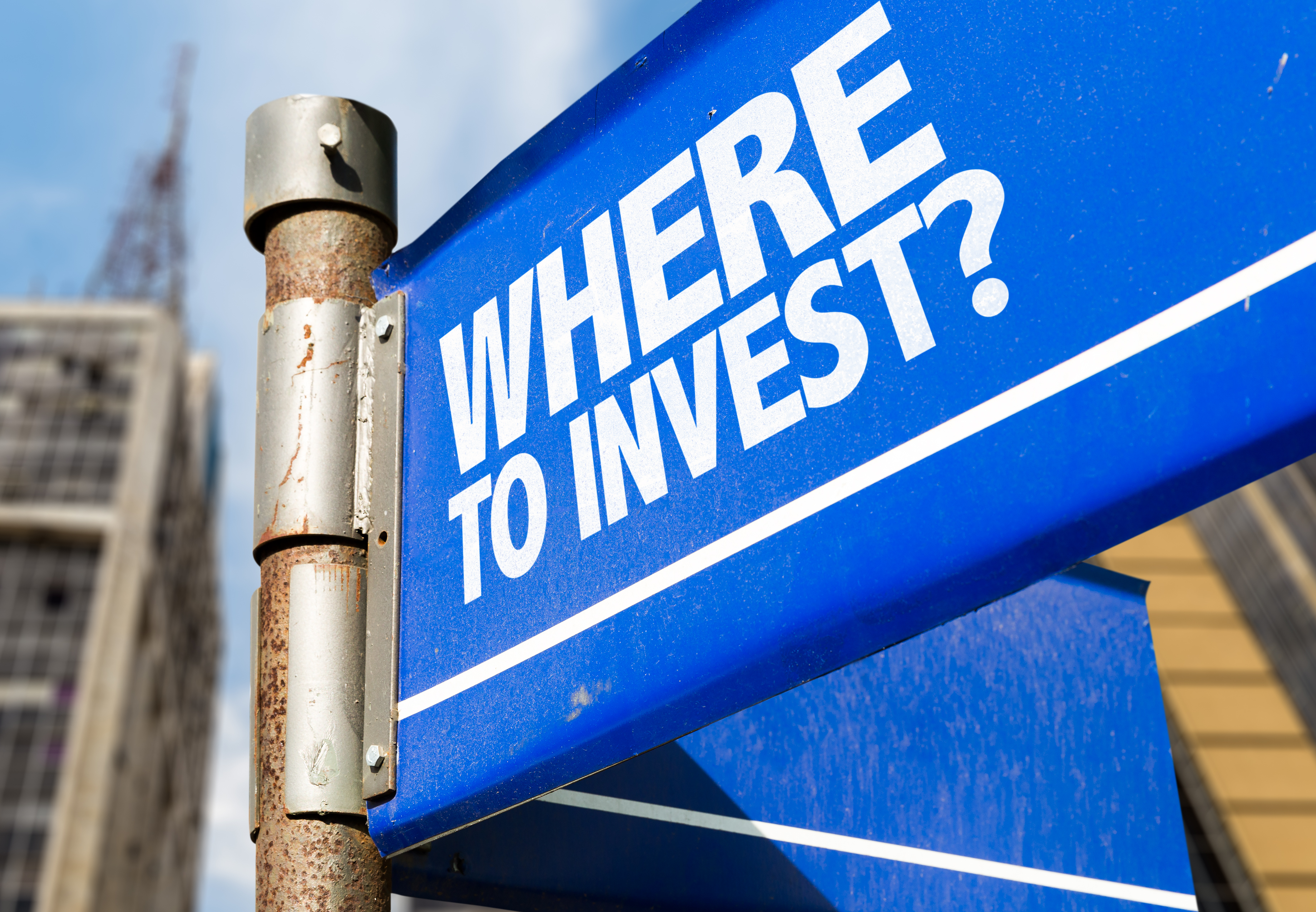 a street sign that reads where to invest
