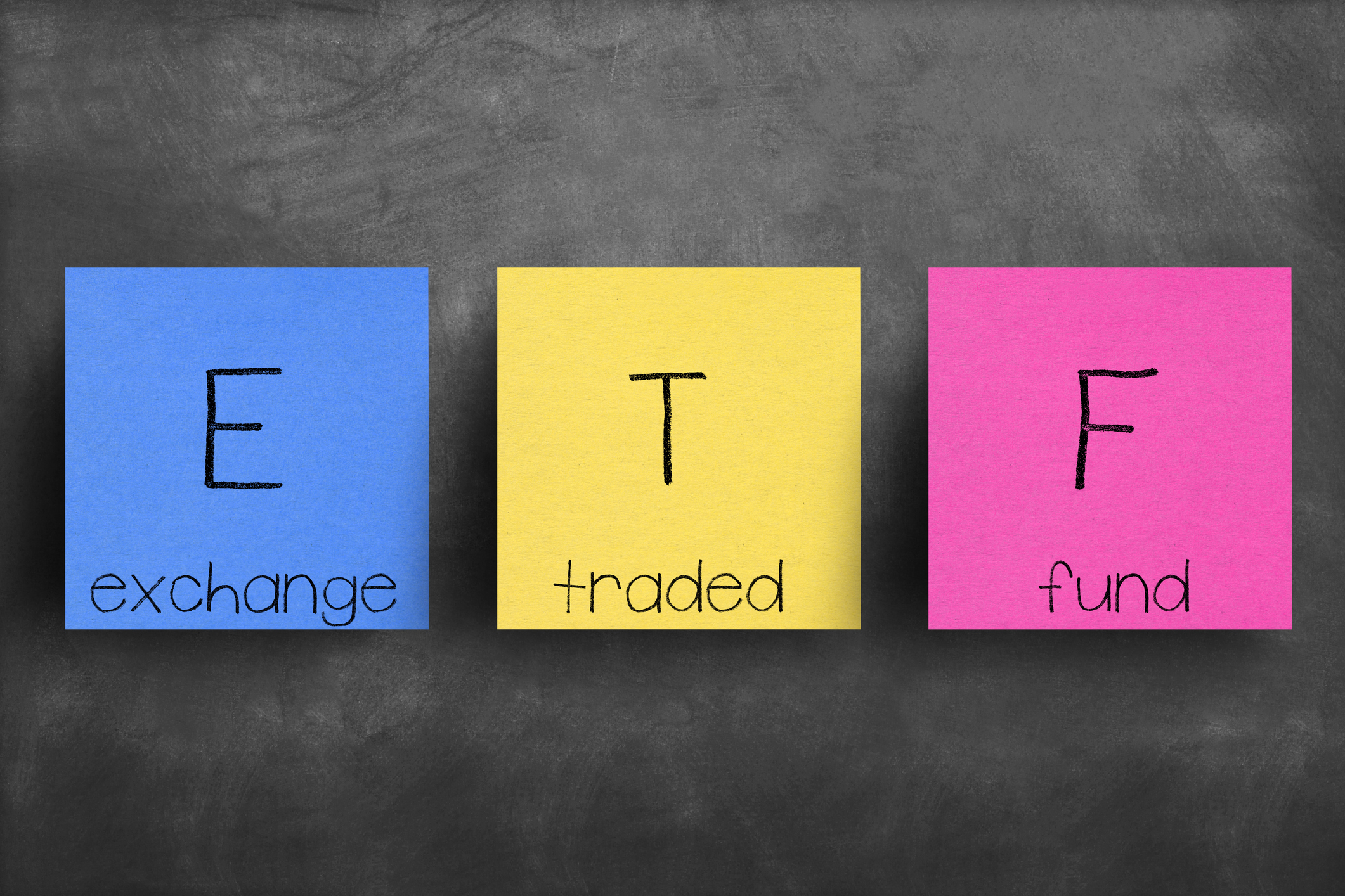 red yellow and blue color blocks with the acronym ETF on them and the words exchange traded fund Red yellow and blue color blocks with the acronym ETF on them and the words exchange traded fund.