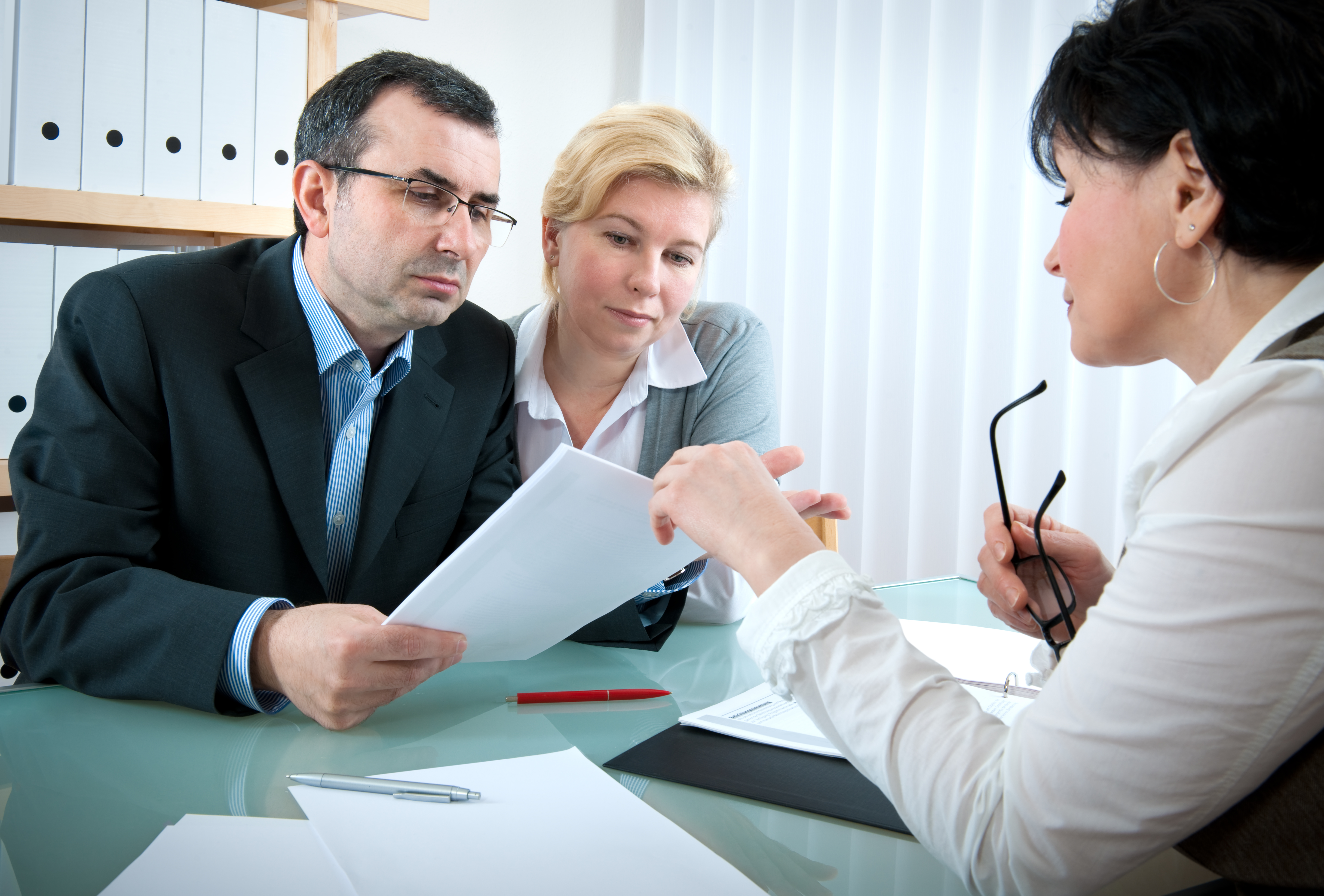 40-something couple meeting with investment advisor