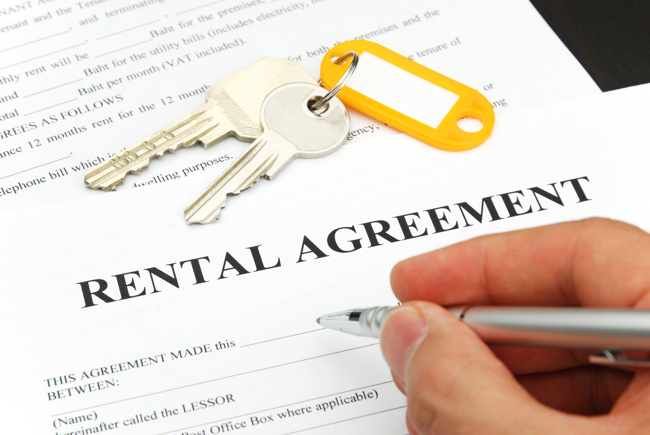 Pen in hand, signing a rental agreement. Pen in hand, signing a rental agreement.