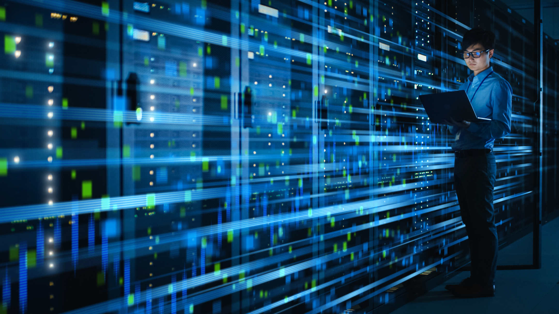 A person in a data center. A person in a data center.