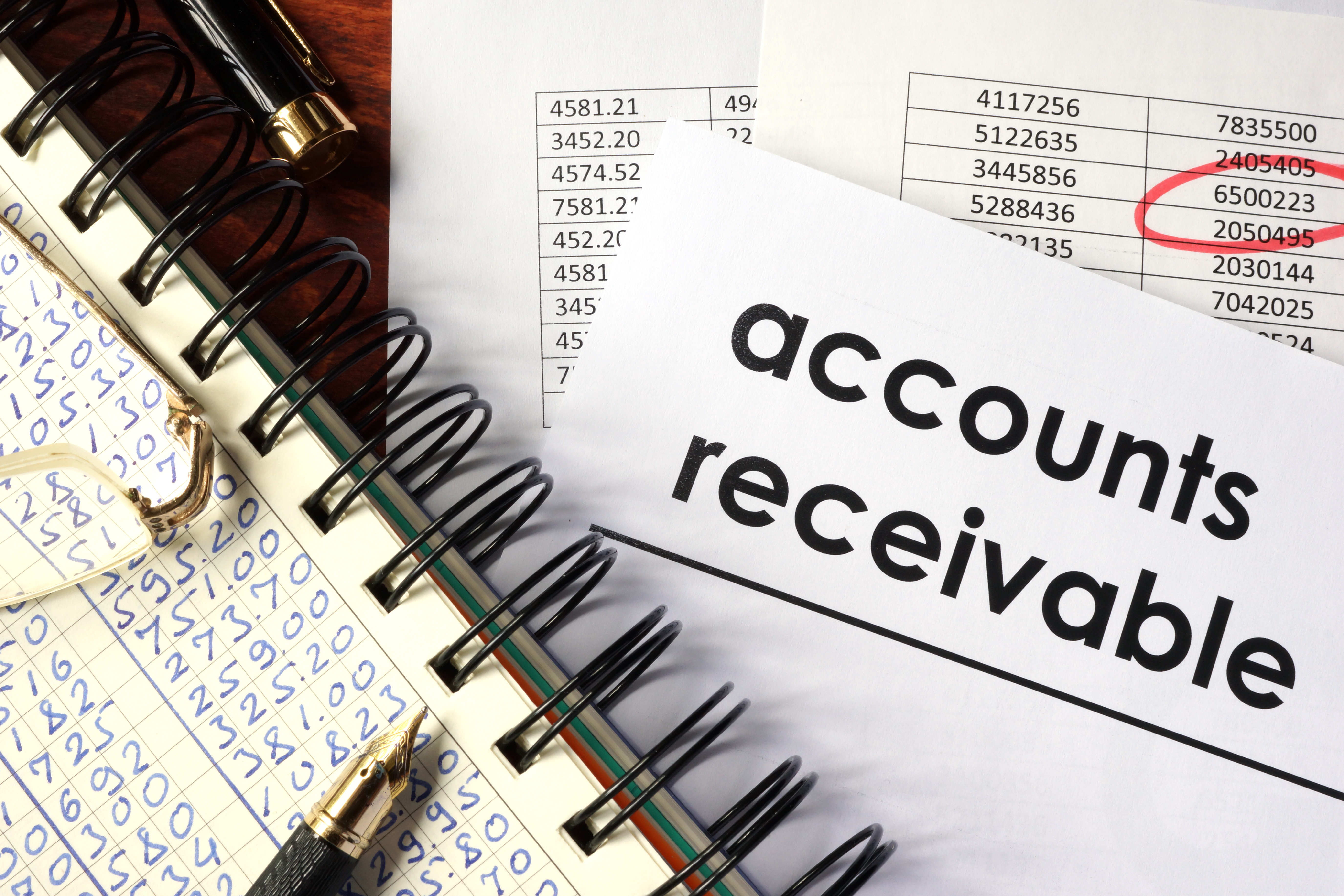 An accounting ledger and paper labeled Accounts Receivables. An accounting ledger and paper labeled Accounts Receivables.