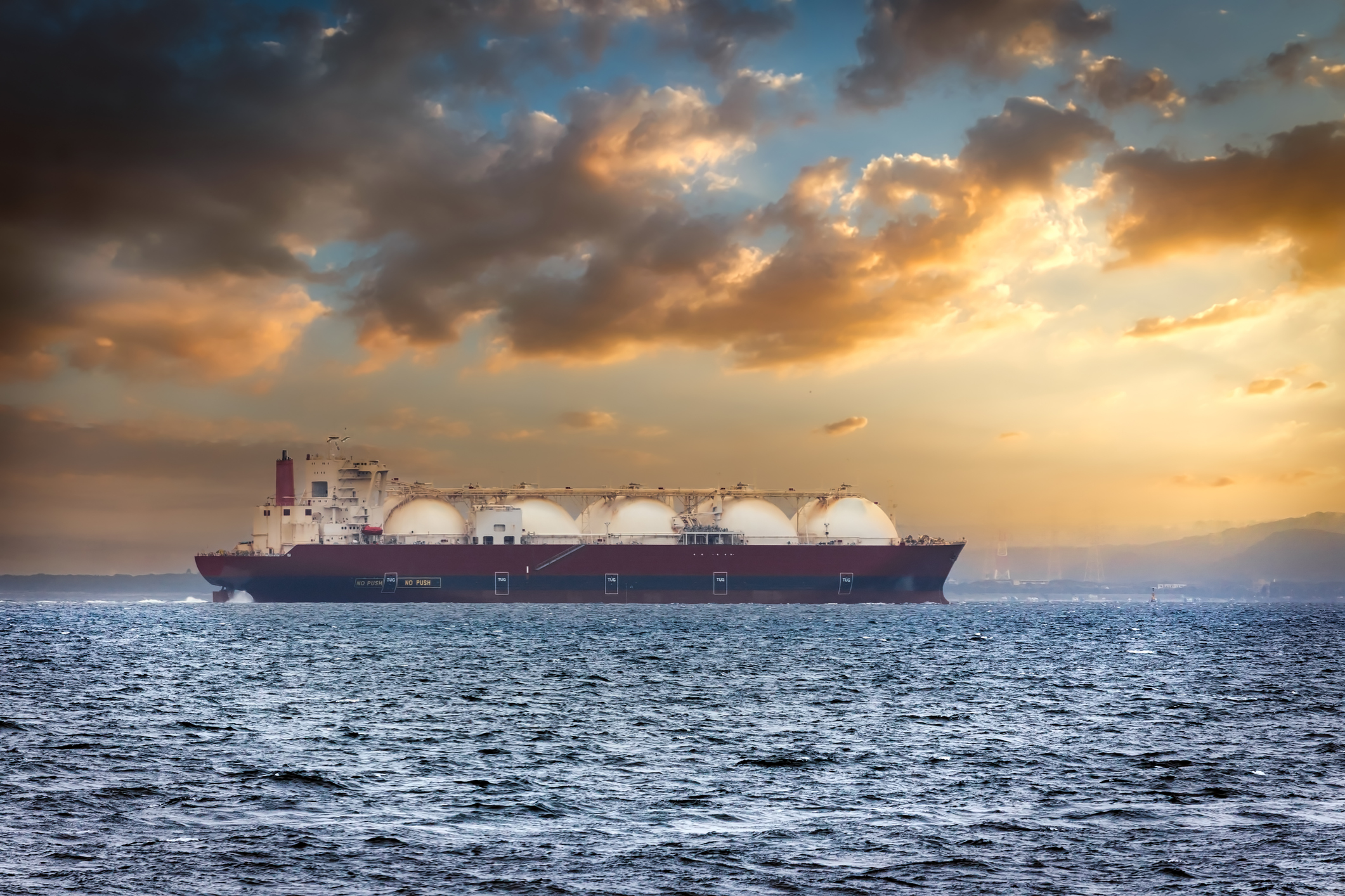 An LNG tanker at sunset. An LNG tanker at sunset.