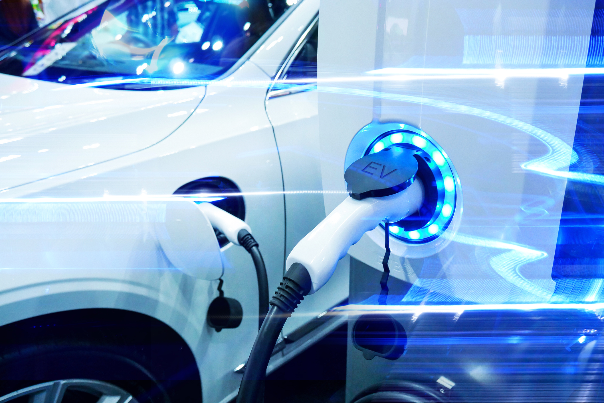 An electric vehicle at a charging station. An electric vehicle at a charging station.