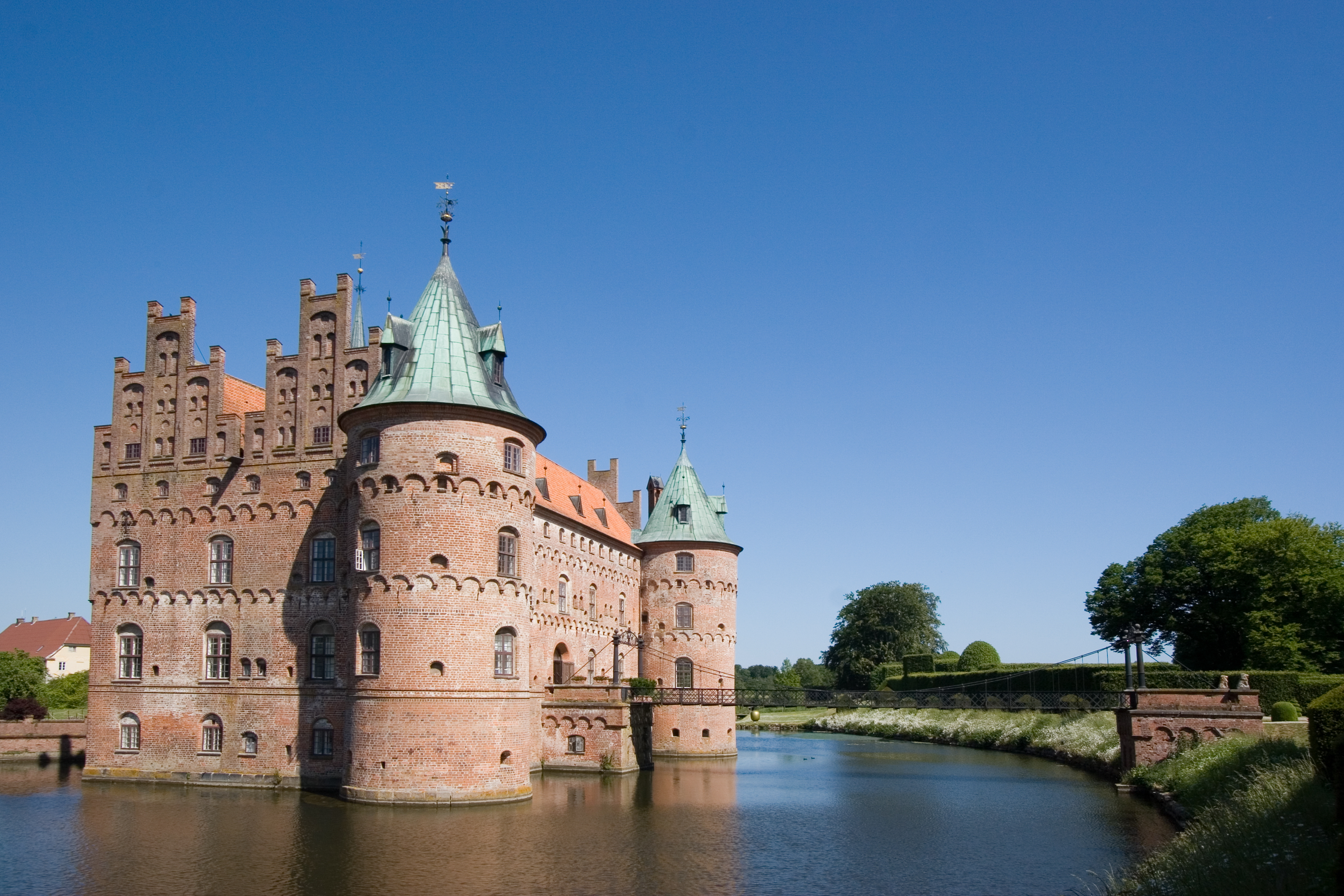 A castle surrounded by a moat. A castle surrounded by a moat.