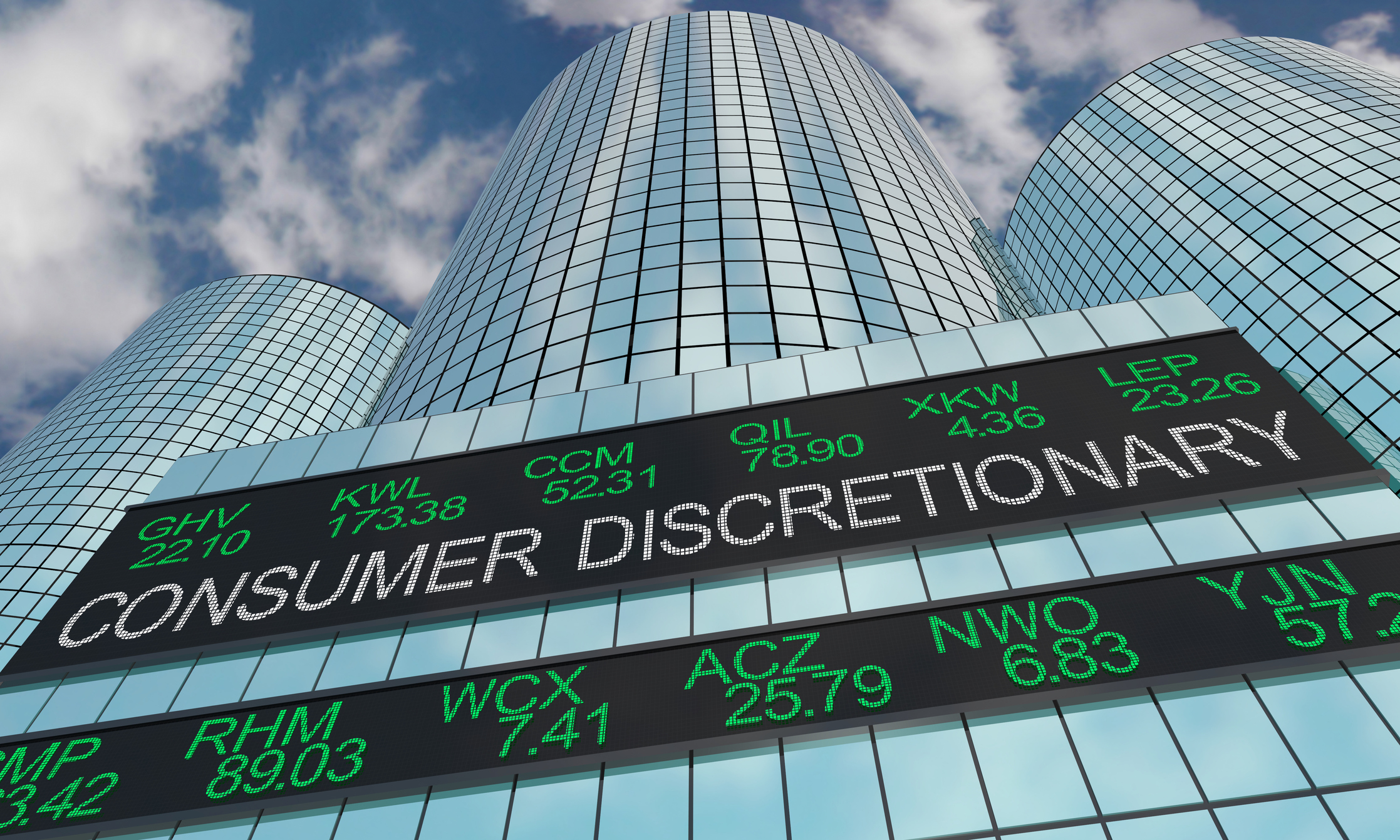 Consumer Discretionary Stocks A building stretching into the sky with a digital sign that reads Consumer Discretionary and shows tickers and stock prices.