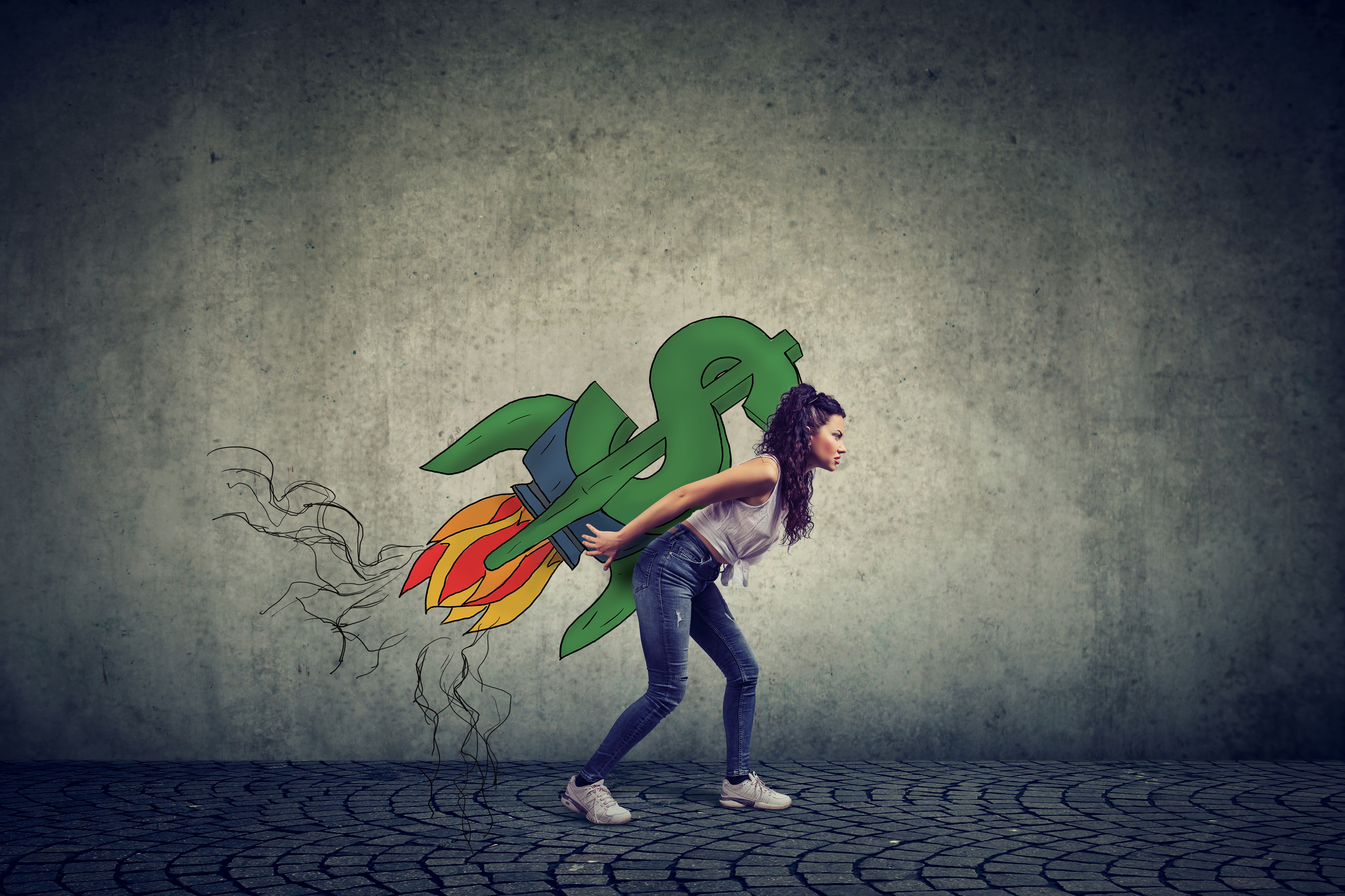 Woman holding a drawn dollar sign made into a rocket on her back as if to take off.
