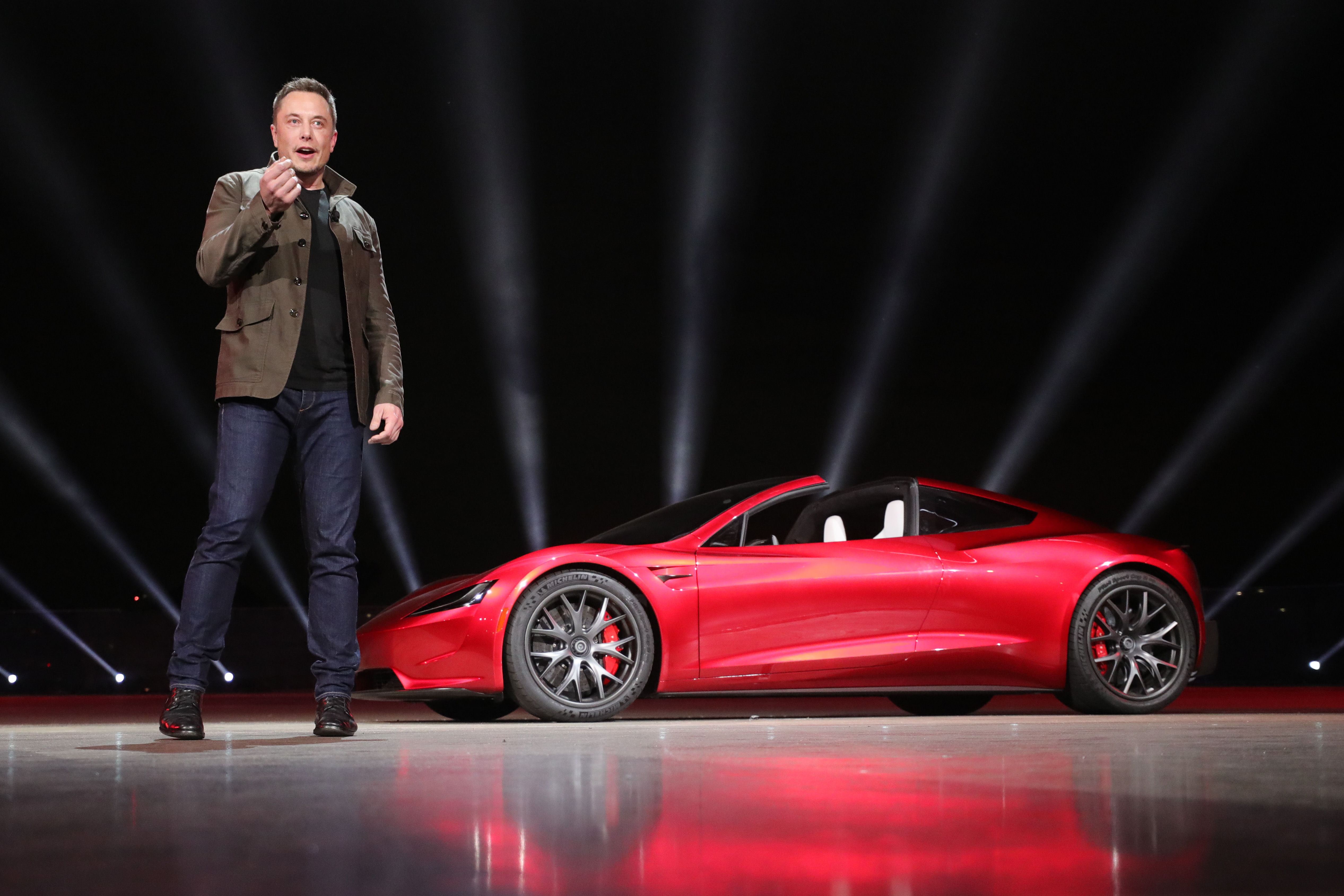 Elon Musk on stage by the Tesla Roadster. Elon Musk on stage by the Tesla Roadster.
