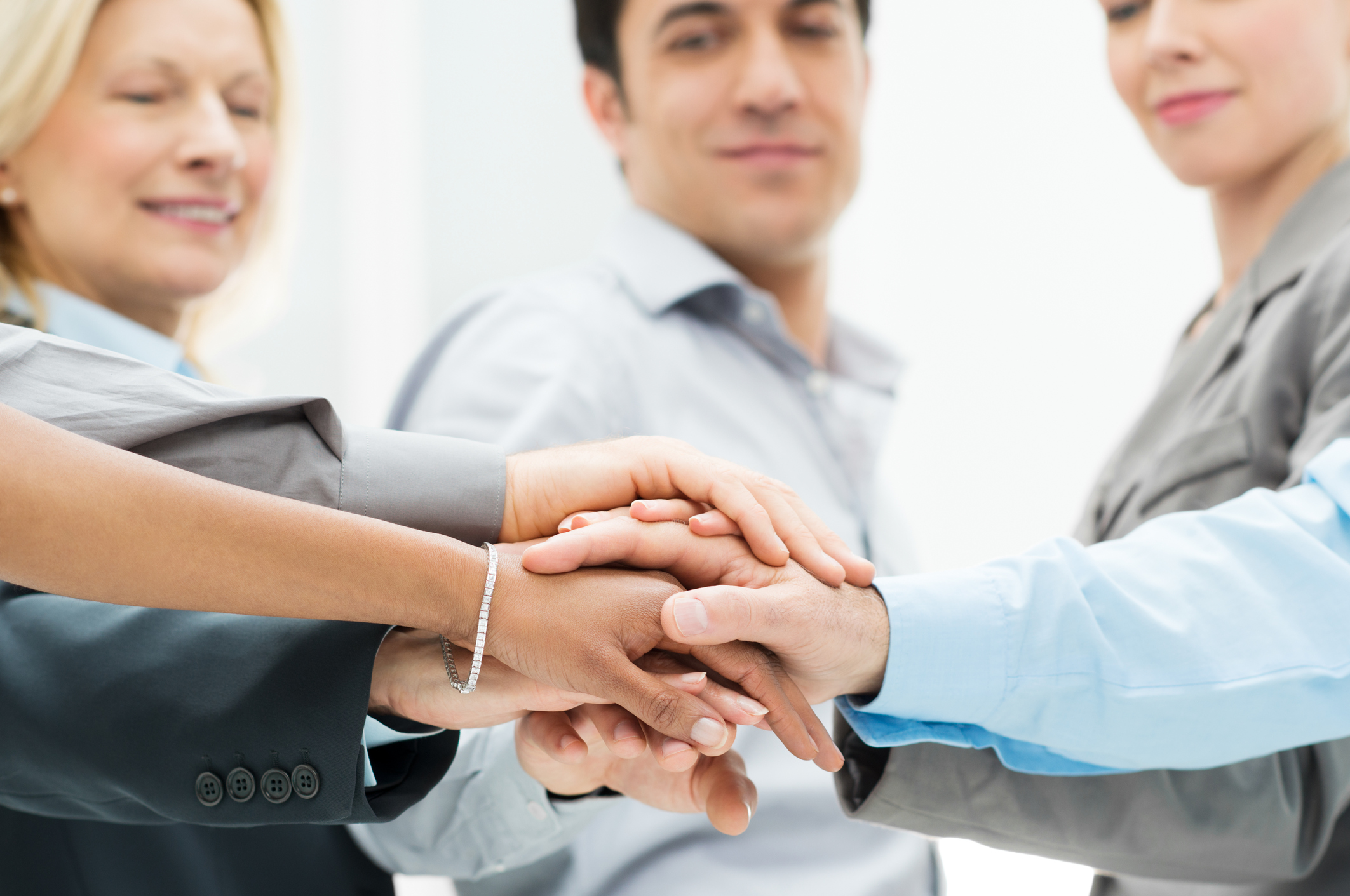 employees putting their hands together
