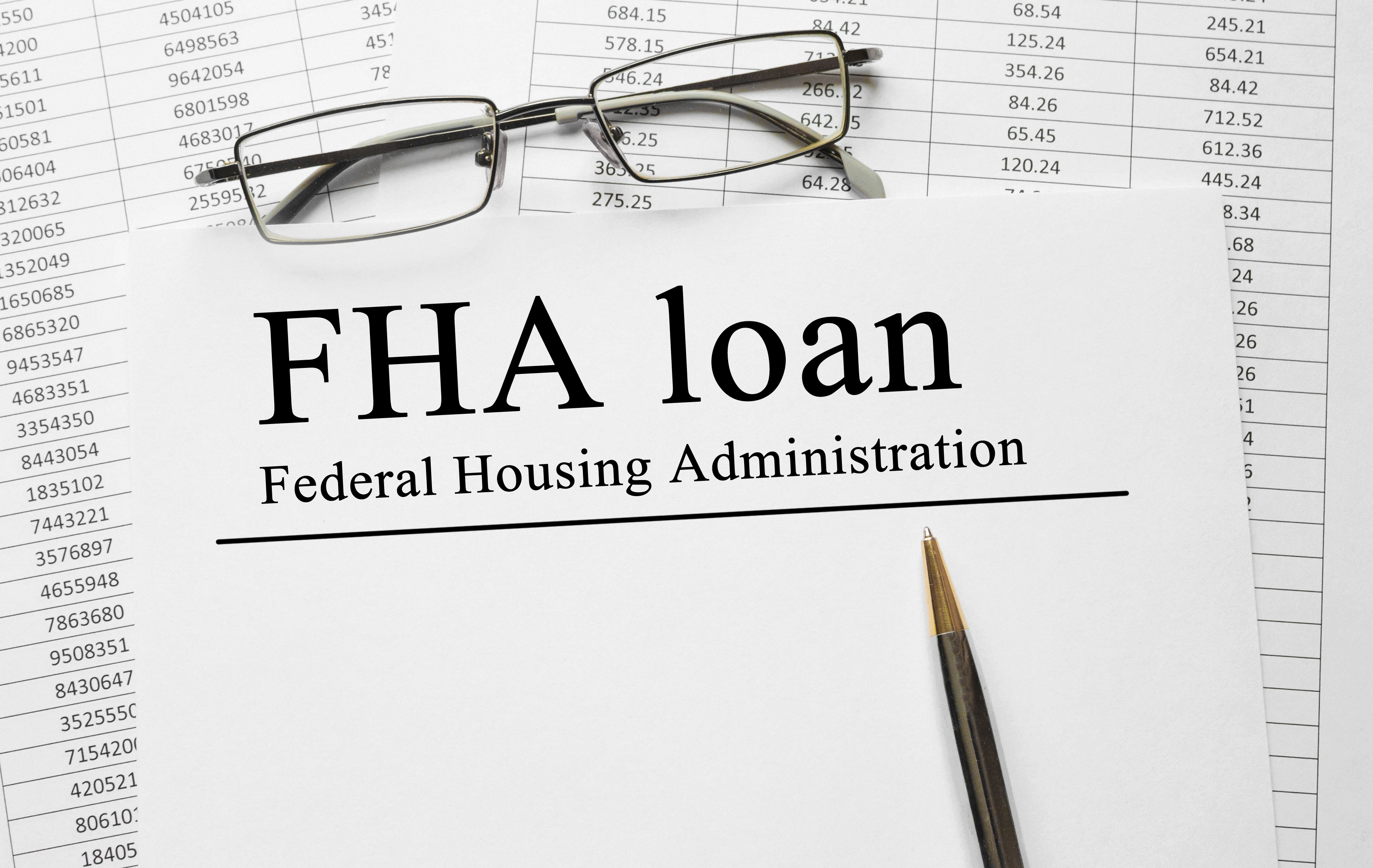 FHA loan.jpg Charts with a piece of paper lying on top that says Federal Housing Administration FHA loan.