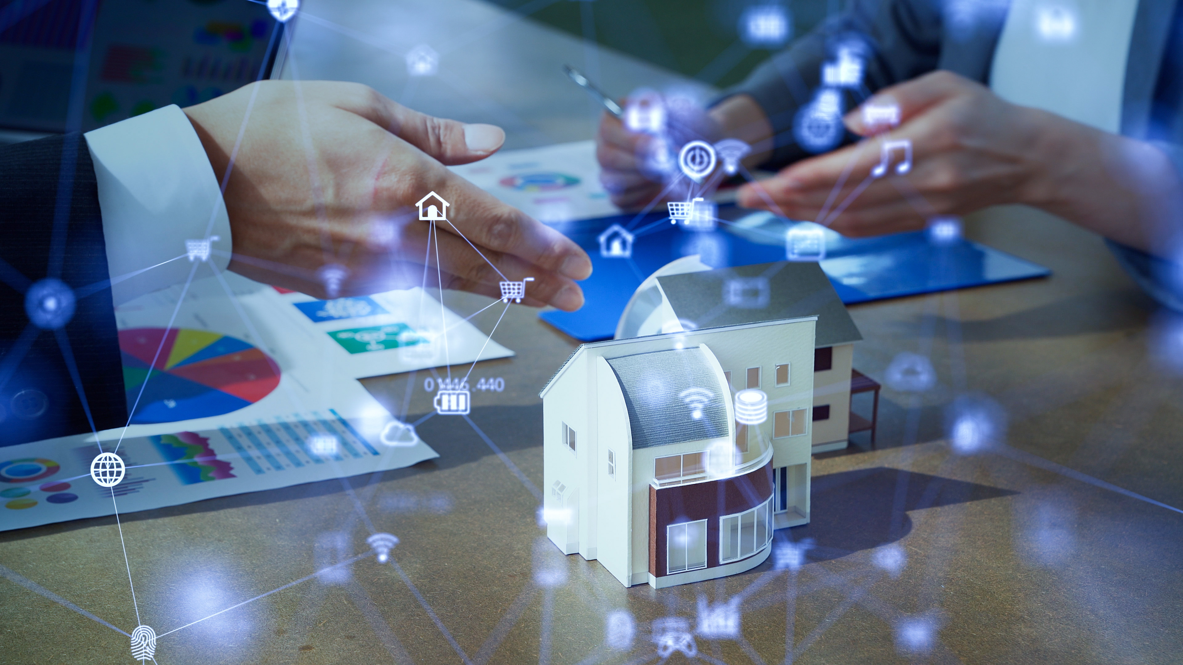 5g_real_estate Image of model home on a desk with visual representation of smart home automations.
