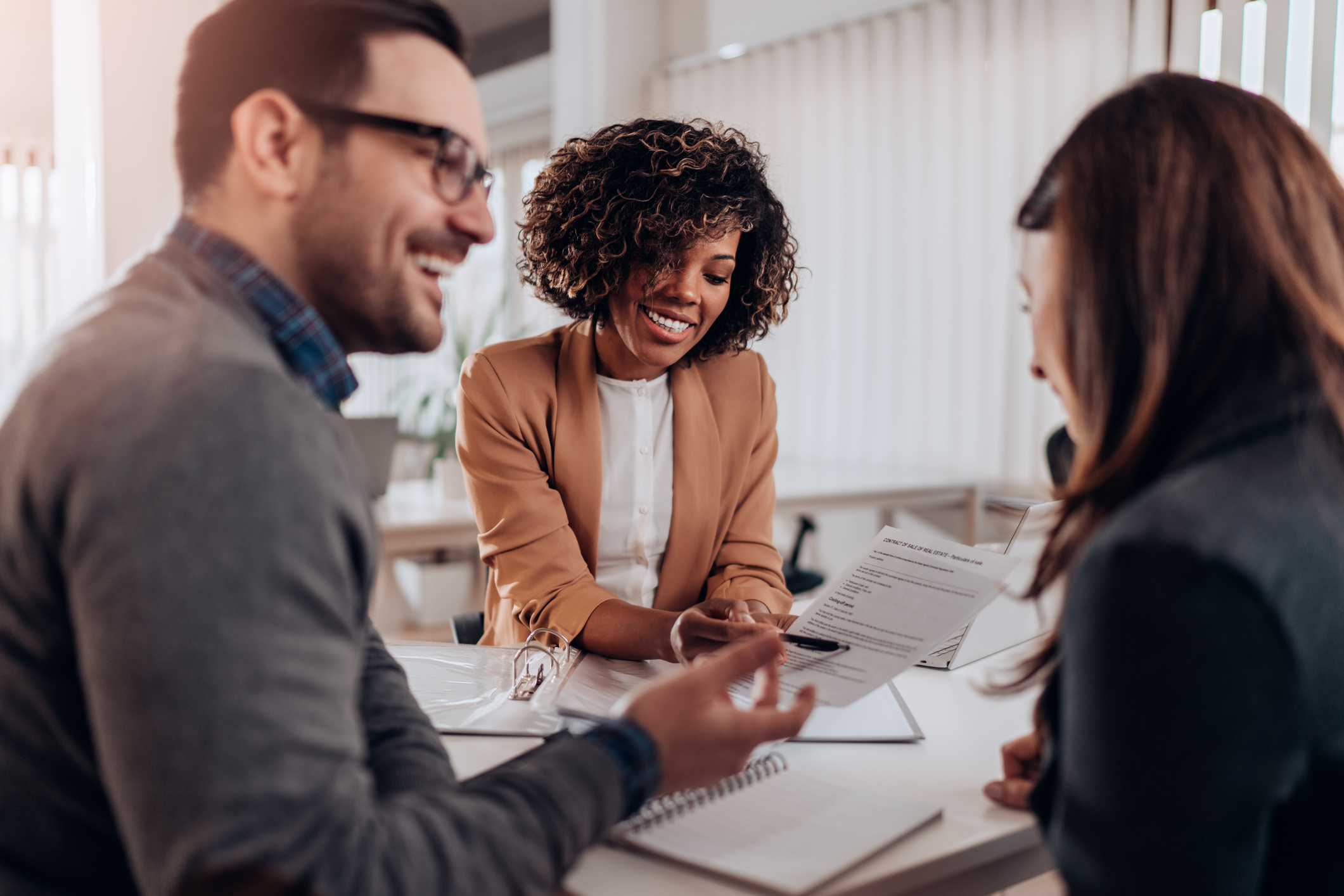 private_reits_three_people_having_a_meeting Group of people having a meeting at the office.