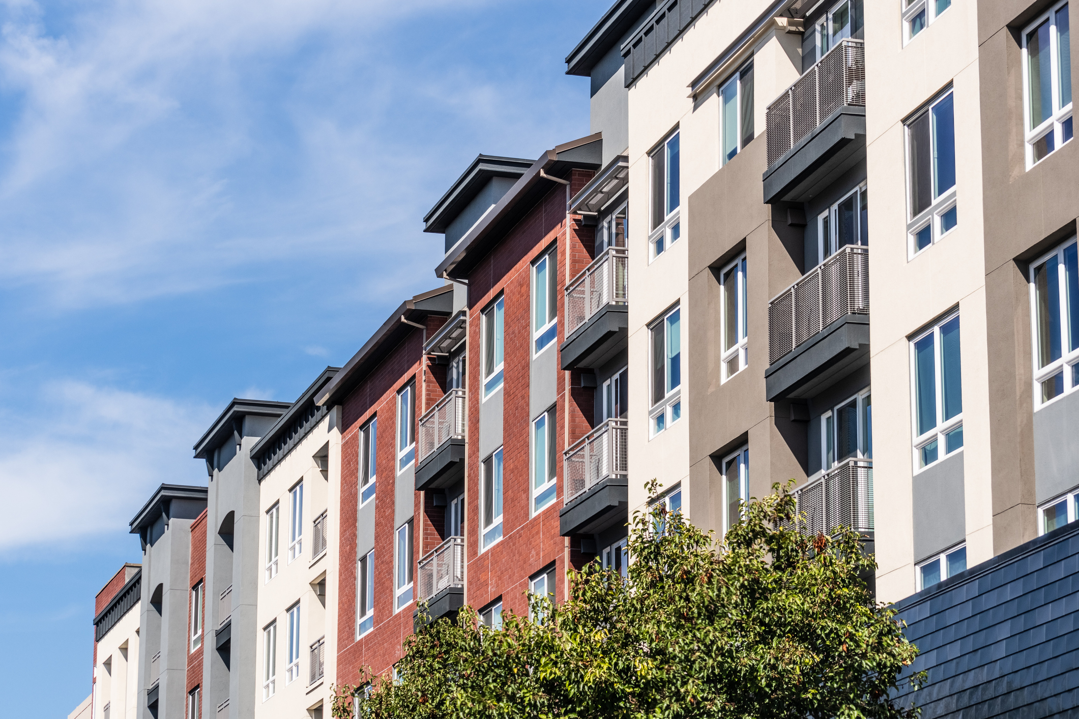 where_to_invest_residential_vs_commercial_real_estate Exterior view of modern apartment building in San Francisco.