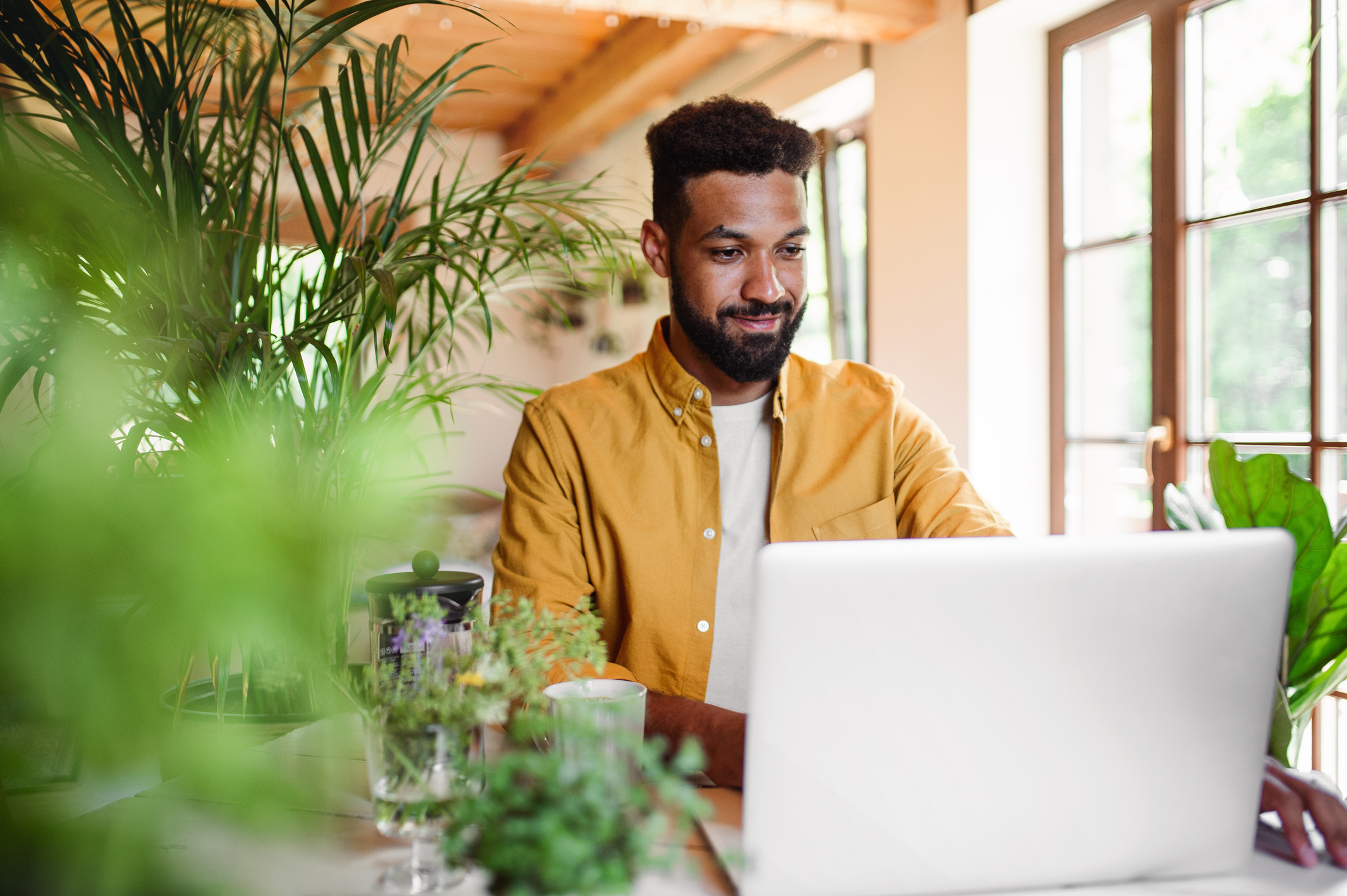 high_yield_dividend_reits_to_buy_now_person_on_laptop A person with a laptop and coffee.