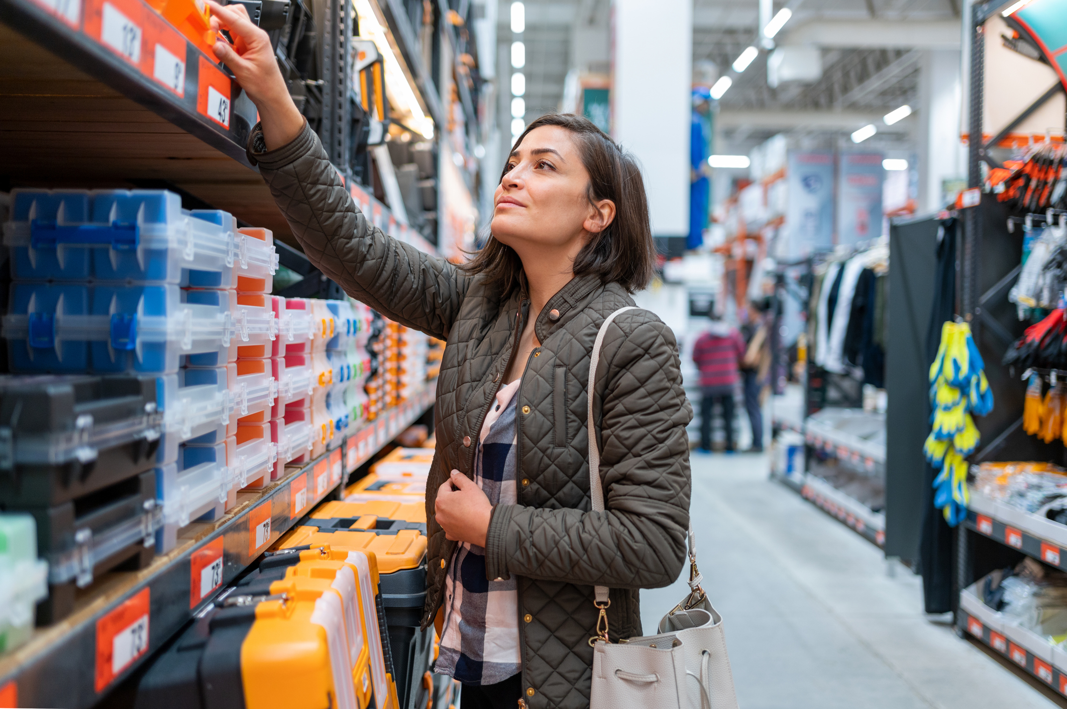 hypermarket_pros_and_cons_woman_shopping Woman Choosing Materials in Supercenter Store