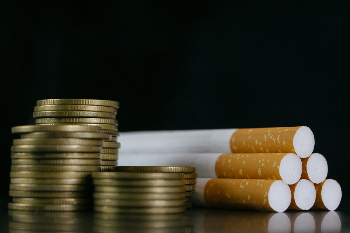 GettyImages-cigarettes and coins lying on a table Cigarettes and coins lying on a table.