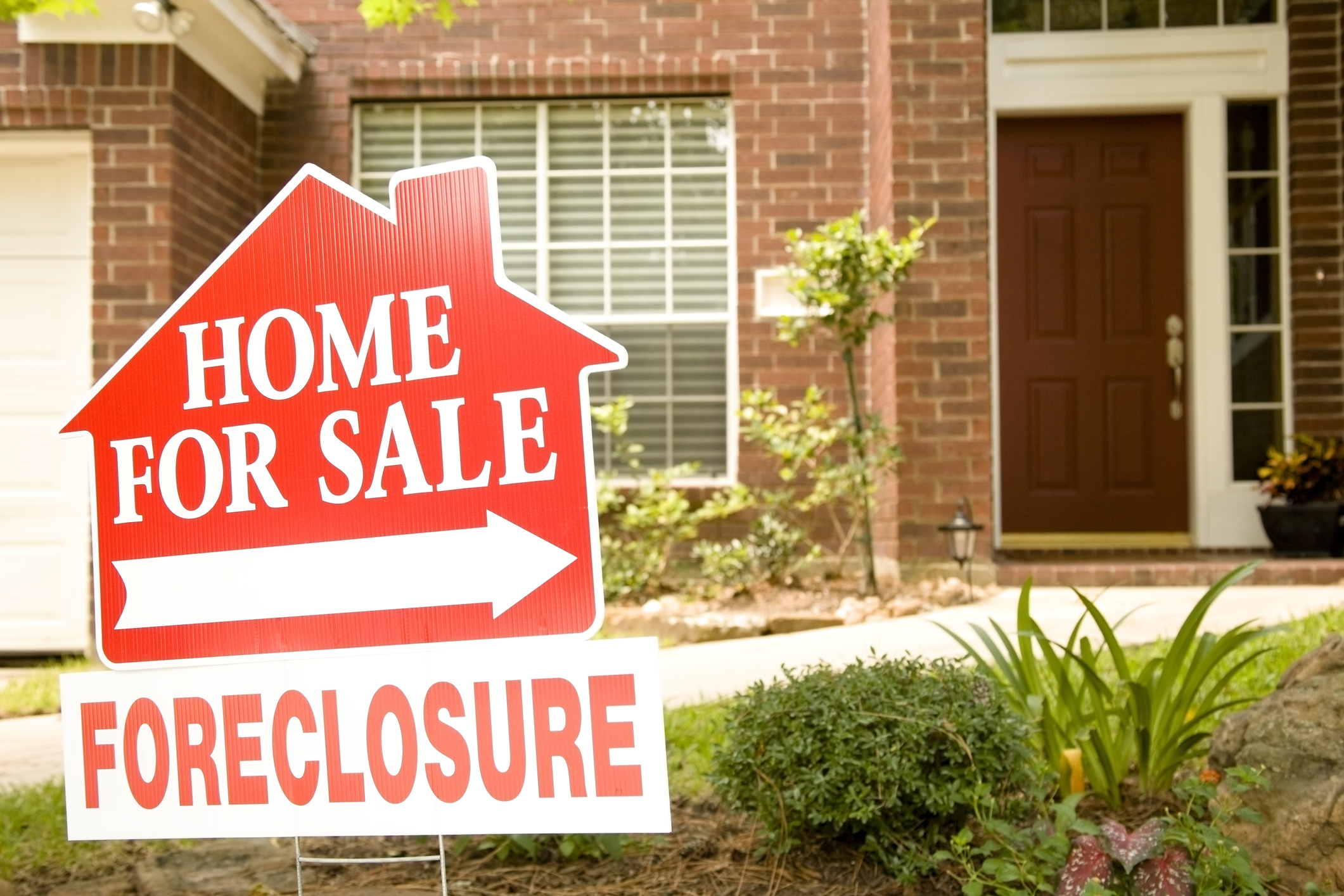 house foreclosure Foreclosure sign in front of house.