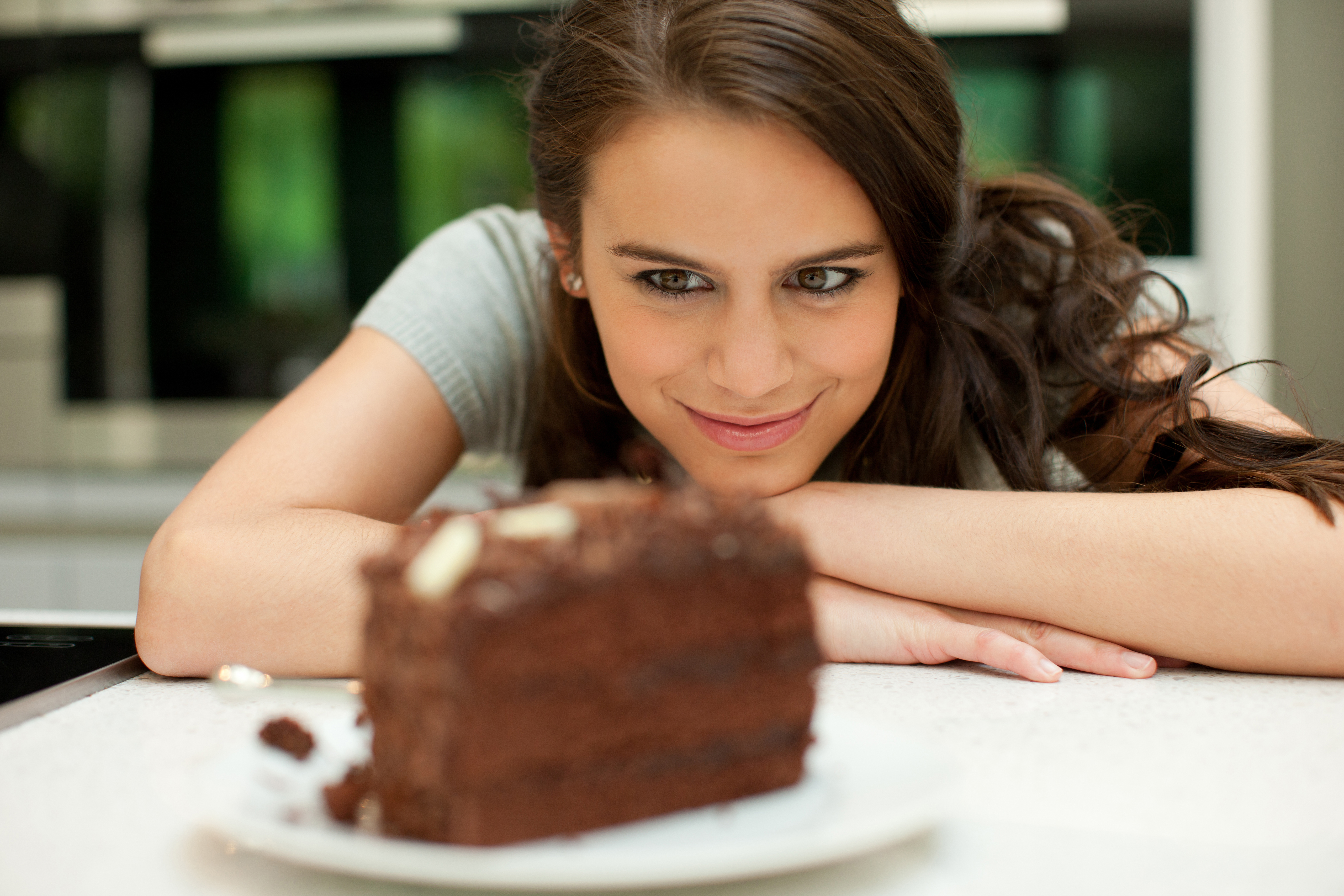 Woman looking at chocolate cake Woman looking at chocolate cake