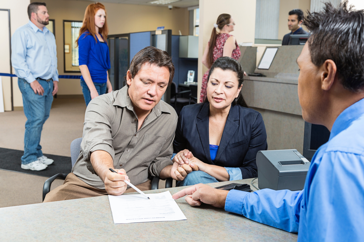 Couple at a bank A couple at a bank going over documents.
