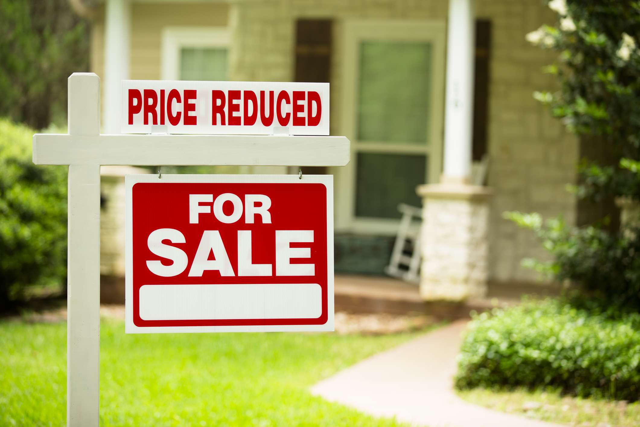For sale sign with the words Price Reduced added.