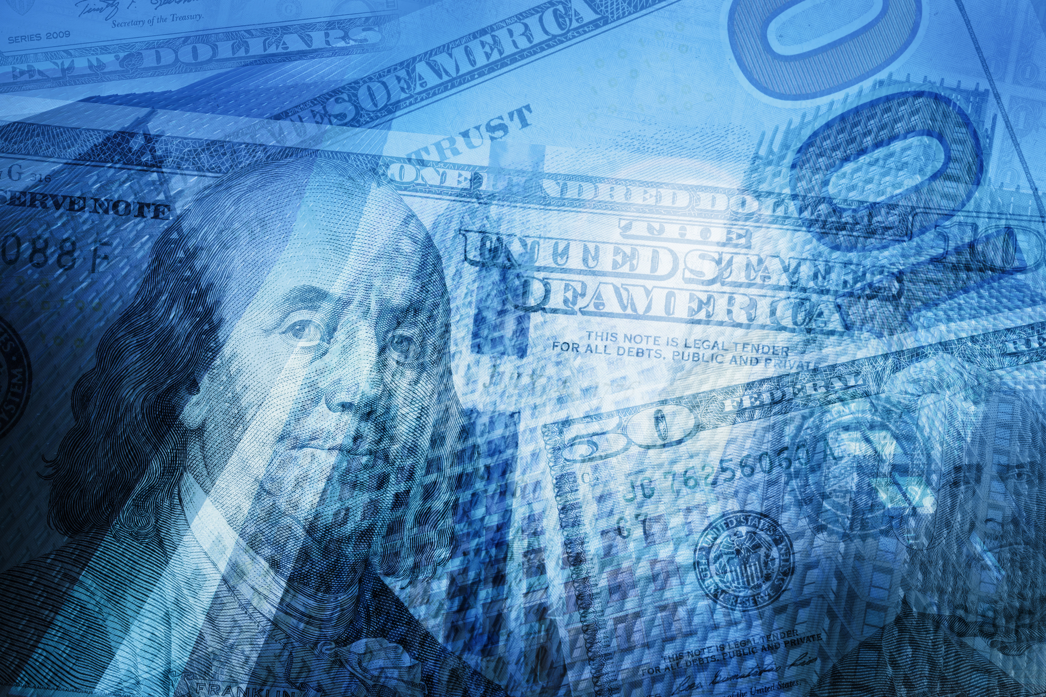 Banking and money Various denominations of U.S. currency superimposed over one another in a pile.