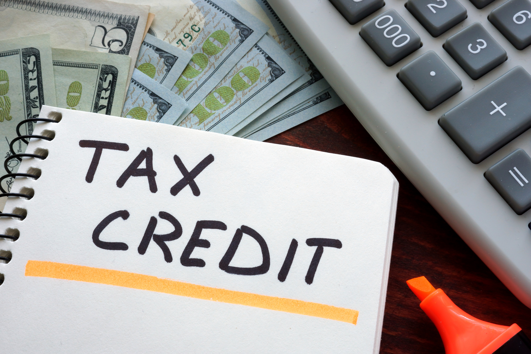 Getty - tax credit credits deduction taxes.jpg The words Tax Credit written on paper.